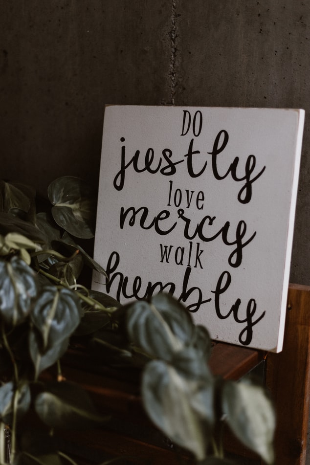 A white canvas with the words do justly, love mercy, walk humbly.